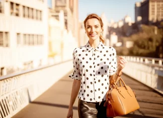 What Are The Things That Happy and Healthy People Do Everyday? Radiant and cheerful young woman walking across bridge in morning sunlight enjoying a healthy lifestyle