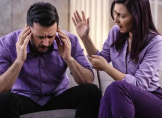 Paranoia Can Ruin A Relationship Distressed couple on sofa experiencing emotional strain and communication breakdown