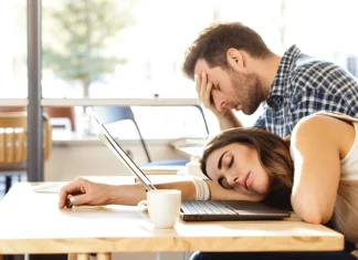 Reasons Why You Are Exhausted All The Time Fatigued professional in knit sweater resting head on cafe desk in daytime exhaustion