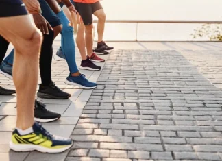 Things To Know Before Running Your First 5k Runner jogging through park trail preparing for their first 5k race