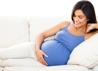 Avoid Stress During Pregnancy Calm expectant mother relaxing in sunlit room practicing stress reduction