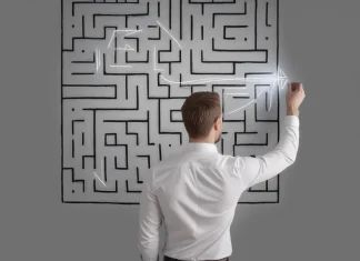 11 Steps to Solving Any Problem: A Framework From Decision Science Professional businessman drawing a strategic solution path through a complex slate wall maze